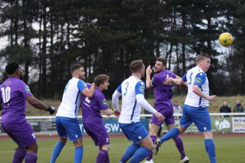 Tootings Sam Flegg (2nd R) heads clear from Mark Kirby (R)