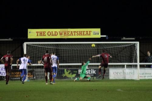 Enfield keeper Joe Wright turns Sean Cronins (maroon 5) penalty on to the crossbar