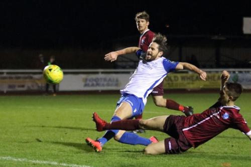 Enfields Drew Roberts (white) shoots over the bar under pressure from Jake Eales