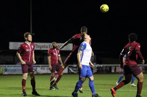 Wingates Ahmet Rifat (3rd L) heads clear from Darren Purse