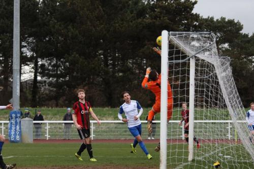 Brightlingsea keeper James Bradbrook tips a cross over the bar