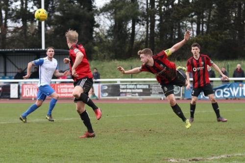 Brightlingseas Matt Cripps (6) heads clear