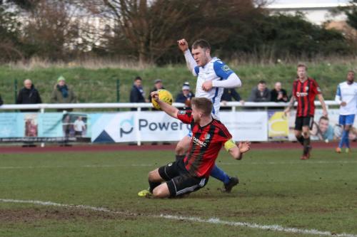 Brightlingseas Matt Cripps (red black) blocks Brad Wadkins shot