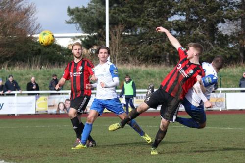 Enfields Brad Wadkins (white, R) beats Matt Cripps to the ball but heads wide