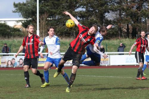 Enfields Brad Wadkins (white, R) beats Matt Cripps to the ball but heads wide48