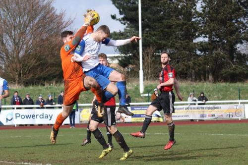 Enfields Brad  Wadkins is adjudged to have fouled Brightlingsea keeper James Bradbrook47