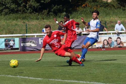 Enfields Mario Noto shoots past the challenges of Adam Richards (L) and Kurtis Cumberbatch