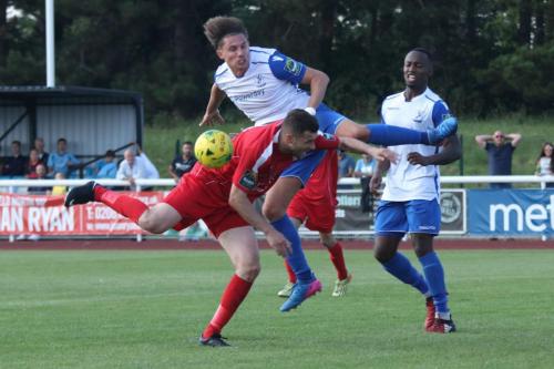 Enfields Sam Youngs challenges Mark McLeod (red)
