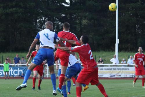Enfields Simon Thomas beats his marker Shaun Preddie (2) to head the winner109