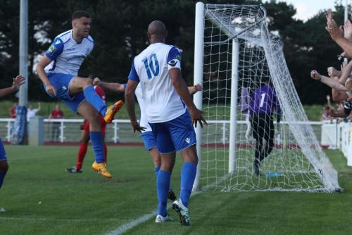 Enfields Taylor McKenzie (L) celebrates Simon Thomass (10) winning goal