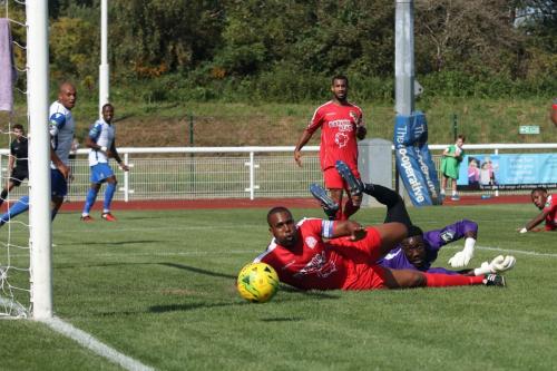 Harrow captain Curtis Ujah and keeper Melvin Minter watch as the ball rolls wide