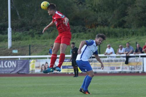 Harrows Adam Richards (L) heads clear from Drew Roberts