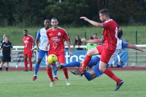 Harrows Mark McLeod (8) clears from Enfields Drew Roberts