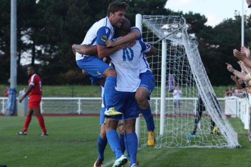 Jack Higgs (L) joins the celebrations for the winning goal, scored by Simon Thomas (10)