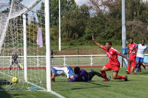 Simon Thomas bundles the ball home for the opening Enfield goal