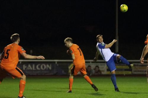 Enfields Darren Purse (R) skies an attempted volley