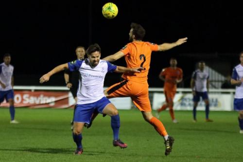 Enfields Drew Roberts (L) challenges Joe Marsden