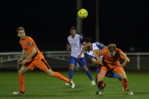 Enfields Mario Noto (white, R) challenges Byron Lawrence