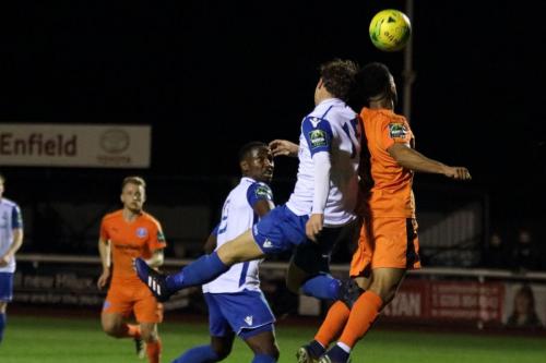 Enfields Mickey Parcell (white) challenges Seb Dunbar