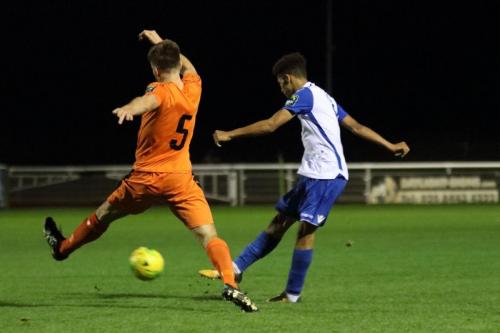 Enfields Montell Moore shoots as Joe Jefford tries to block