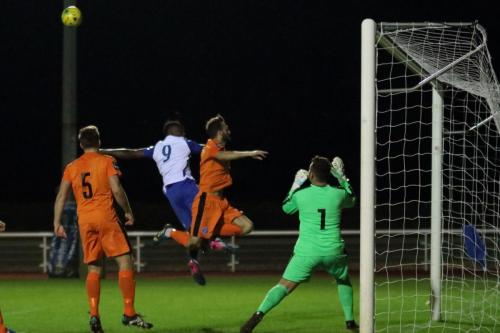 Leistons Joe Marsden (orange, R) beats Ryan Blake to a header