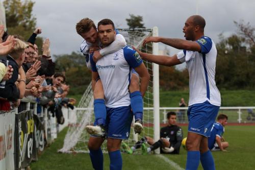 Enfields Taylor McKenzie (L, front) celebrates the winning goal with Mickey Parcell and Simon Thomas (R)