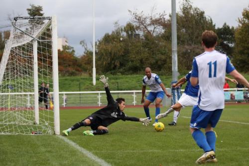 Margates keeper Patrick Lee stretches for Aaron Greenes cross as Liam Friend completes the clearance