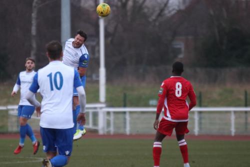 Enfields Adam Martin heads the ball forward