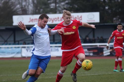 Enfields Liam Hope (L) and Mersthams Liam Harwood Battle for possession