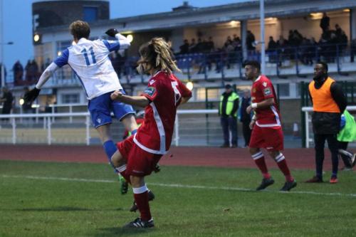 Mersthams Tayshan Hayden-Smith clears from Aaron Greene (11)