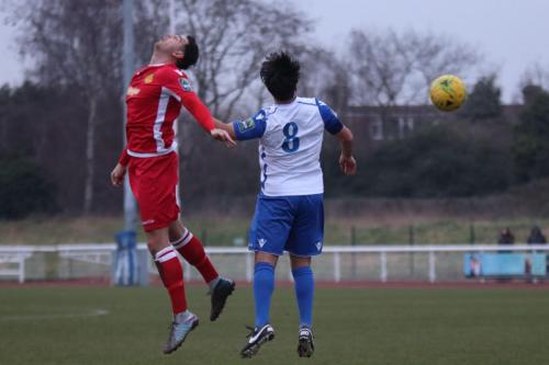 Mersthams Tom Kavanagh (L) and Enfields Mario Moto