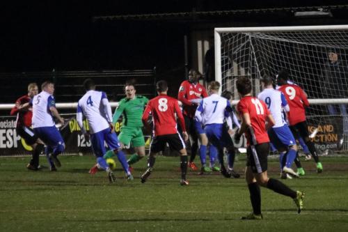 A miscued punch from Enfield keeper Joe Wright leads to a goalmouth scramble