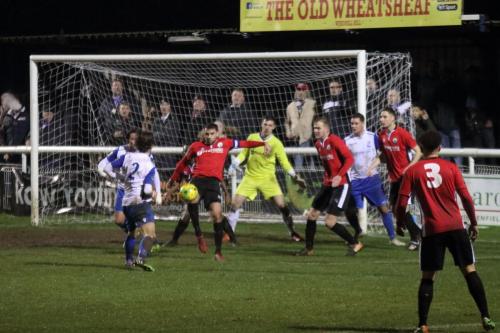 Burgess Hills Jack Brivio (red, L) clears and Enfield attack
