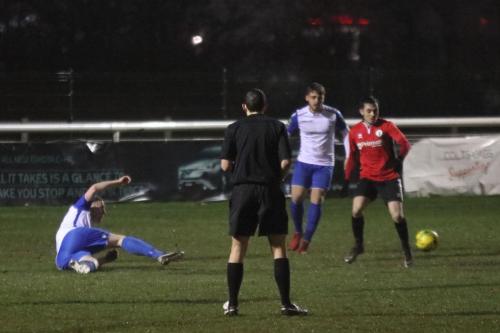 Enfields Mark Kirby (L) clears