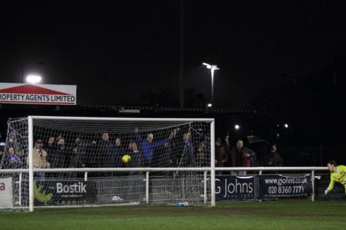 Fans behind the goal are celebrating, but the shot drifts wide