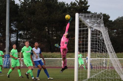 Dorking keeper Slavomir Huk palms away a cross