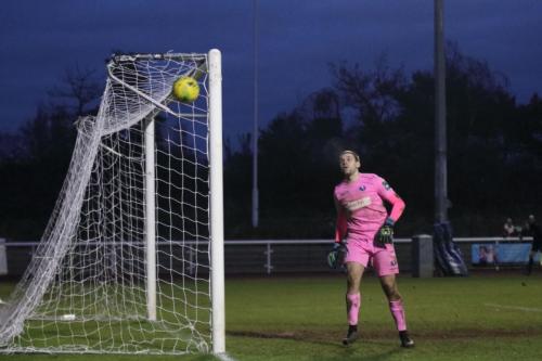 Dorking keeper Slavomir Huk watches as a shot passes just wide