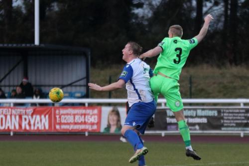 Dorkings Chris Boulter (green) wins a challenge against Mark Kirby