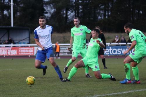 Dorkings David Ray (2nd R) clears from Taylor McKenzie