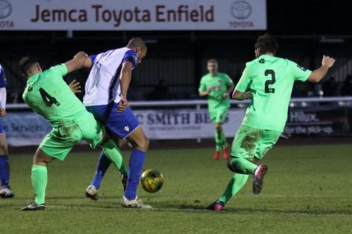 Dorkings David Ray (4) knocks the ball away from Simon Thomas