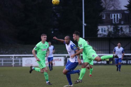 Dorkings David Ray (R) heads clear from Simon Thomas