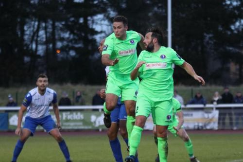 Dorkings David Ray (green, L) and Dean Hamlin attack the ball at a corner