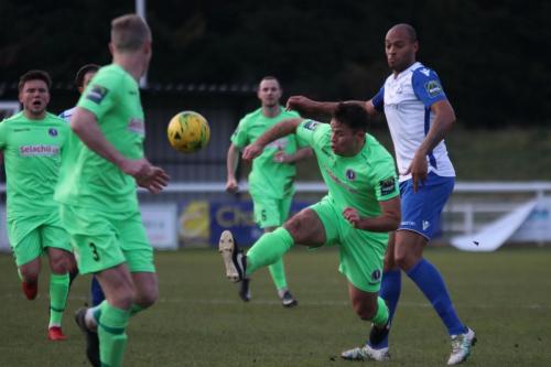 Dorkings David Ray (green, R) clears from Simon Thomas