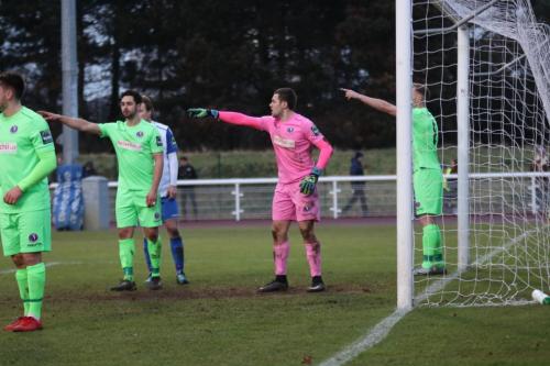 Dorkings Giuseppe Sole (2nd L), keeper Slavomir Huk and Robb Sheridan have all spotted a problem with the marking at a corner