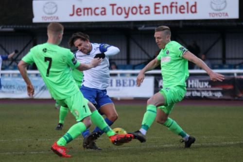 Dorkings Sam Beard (L) and Chris Boulter combine to deflect Sam Youngss shot