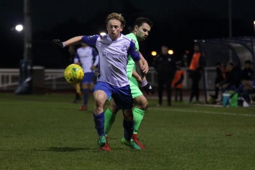 Enfields Aaron Greene (white) spins away from Matt Briggs