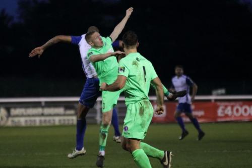 Enfields Simon Thomas (L) challenges Chris Boulter