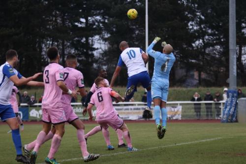 After his previous attempt to catch under pressure led to an own goal, Dulwich keeper Preston Edwards takes no chances and punches clear