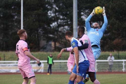 Dulwich keeper Preston Edwards is at full stretch to field a long throw