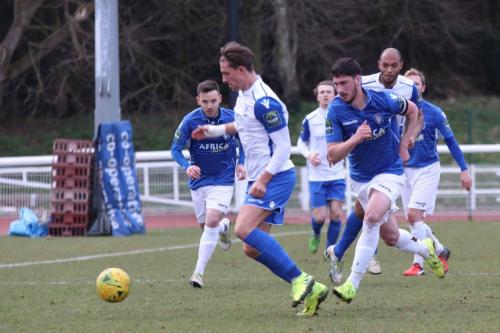 Enfields Sam Youngs pursued by Travis Cole (blue, R)